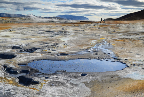 Walking through the smoking fumaroles and boiling mud pots of Namafjall Hverir Geothermal Area, Iceland photo
