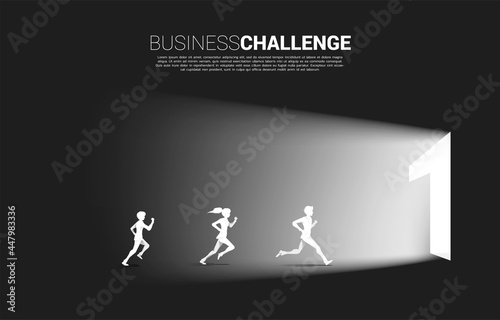 Silhouette of businessman and businesswoman running to exit door number one. Concept of business challenge and competition. photo