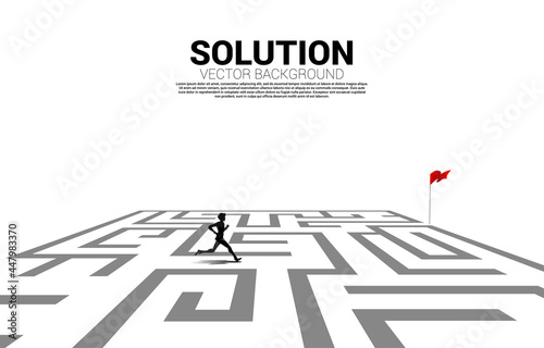 Silhouette of businessman running in maze to red flag. business concept for finding solution and reach goal