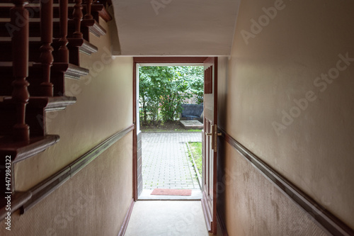 Interior view of corridor, hallway stairway and entrance door on ground floor of apartment building.  photo