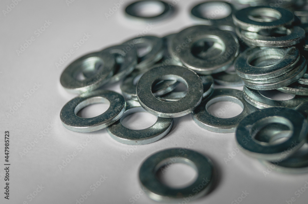 A scattering of metal washers for bolts and screws. A scattering of metal washers for bolts and screws.