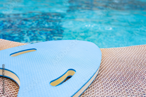 blue floating pad near a swimming pool