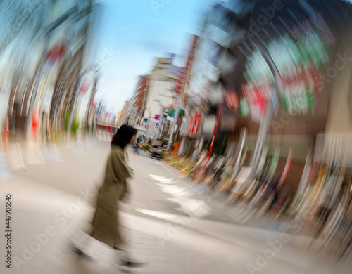 Photography Blurred photo of a woman walking along a shopping street in Tokyo