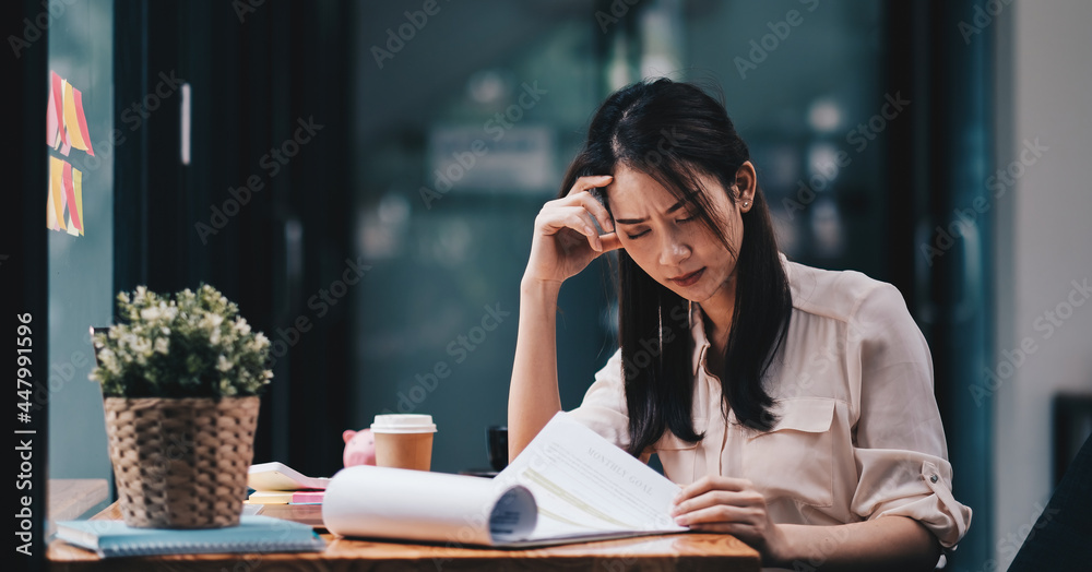 Tired young asian woman feel headache from working problem. Stressed female suffer from headache bad vision sight problem sit at workplace. Tired young asian woman feel headache from working problem. Stressed female suffer from headache bad vision sight problem sit at workplace.