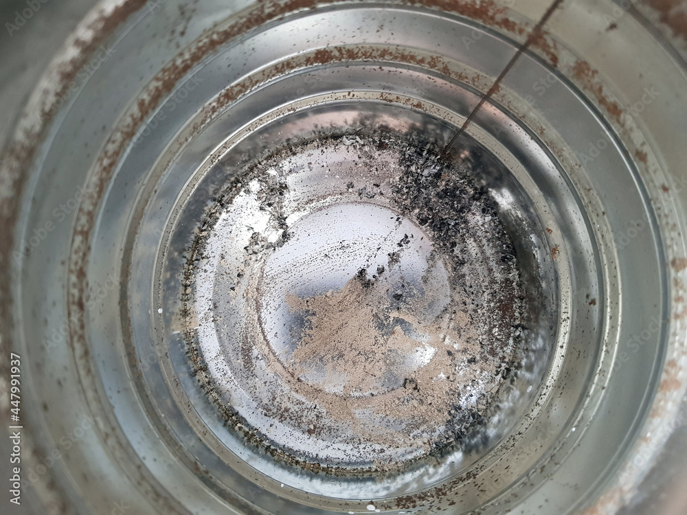 a spiral metal texture inside of a metal can with an ash and dust a spiral metal texture inside of a metal can with an ash and dust