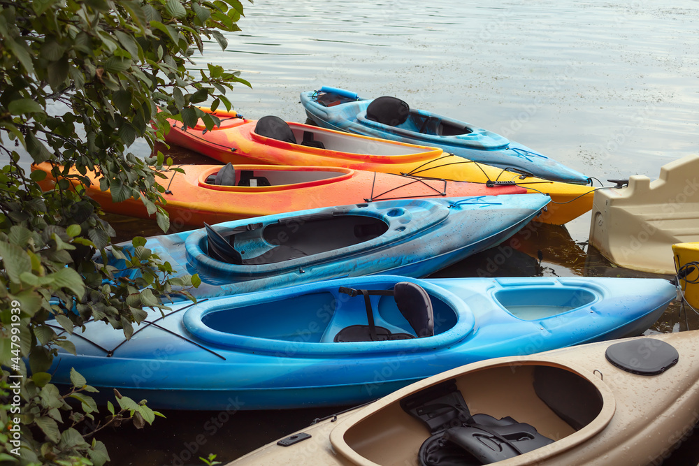 several colorful canoe tied to the dock summer kayaks sports vacations several colorful canoe tied to the dock summer kayaks sports vacations