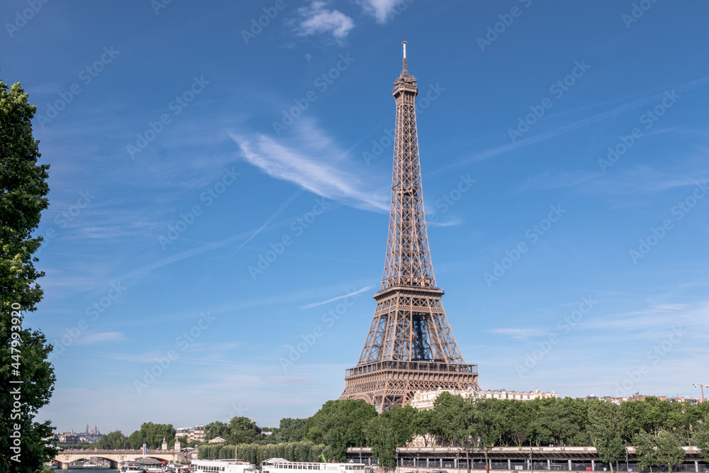 eiffel tower in france on a sunny summer day, by the seine river