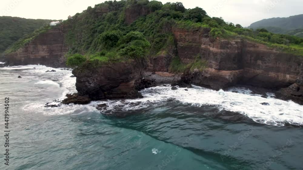 Aerial view of waves break on rocks in a blue ocean. Sea waves on ...