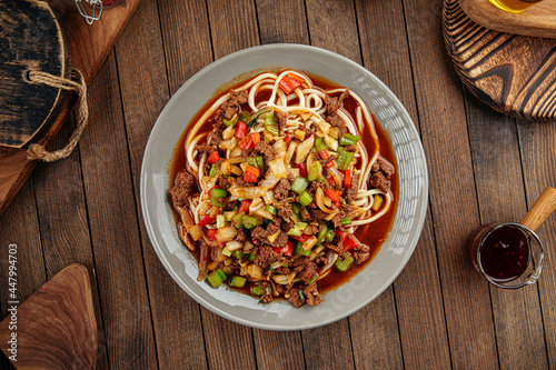 Asian uyghur dish suiru lagman noodles on a wooden background photo