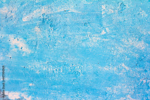 Rough blue abstract grunge vintage texture with paint strokes on aged old wall.