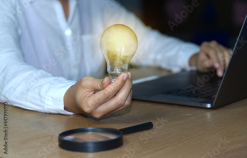 abstract light bulb and magnifying glass concept Business people show new ideas by using innovative technology and creativity.
