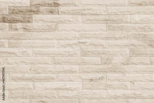 Empty background of wide cream brick wall texture. Beige old brown brick wall concrete or stone textured.