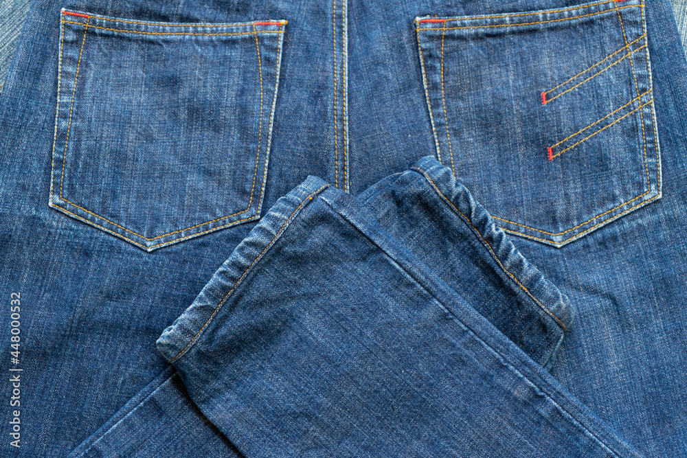 Fototapeta premium Blue Jeans and bleached background,denim with seam of fashion design with pocket.