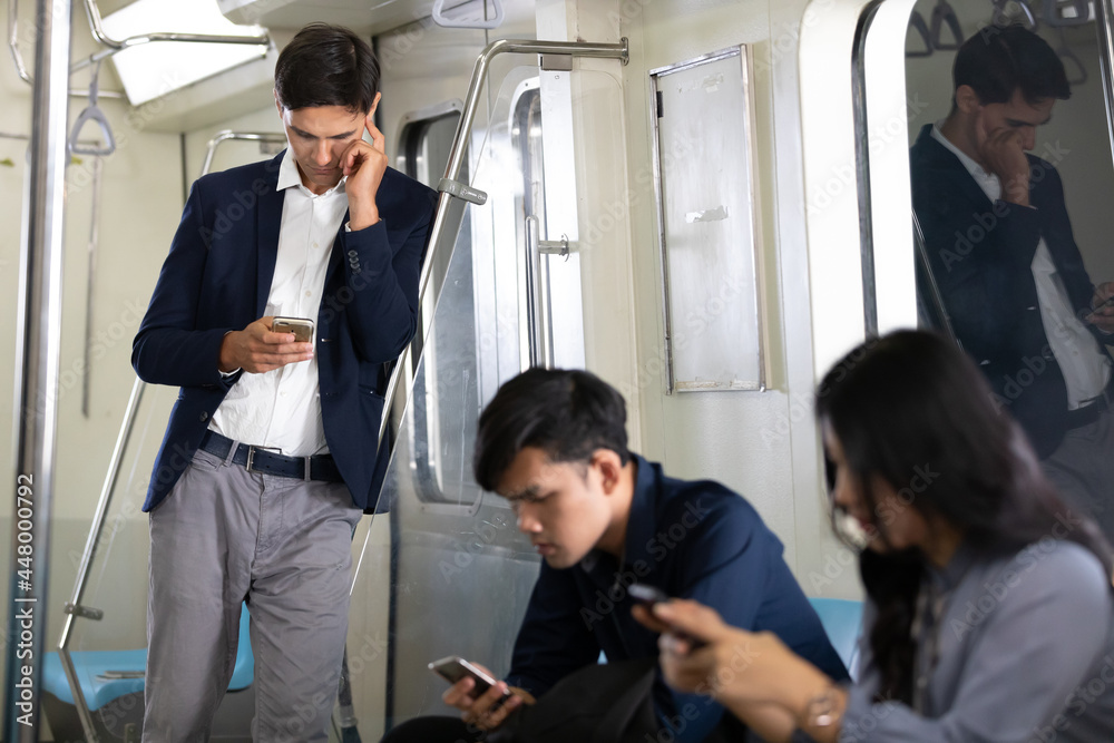 businessman using smartphone in a underground train businessman using smartphone in a underground train