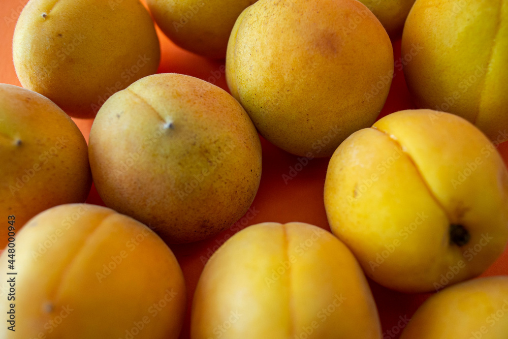 Apricot. Ripe organic apricots on an orange background. Ukraine july 2021