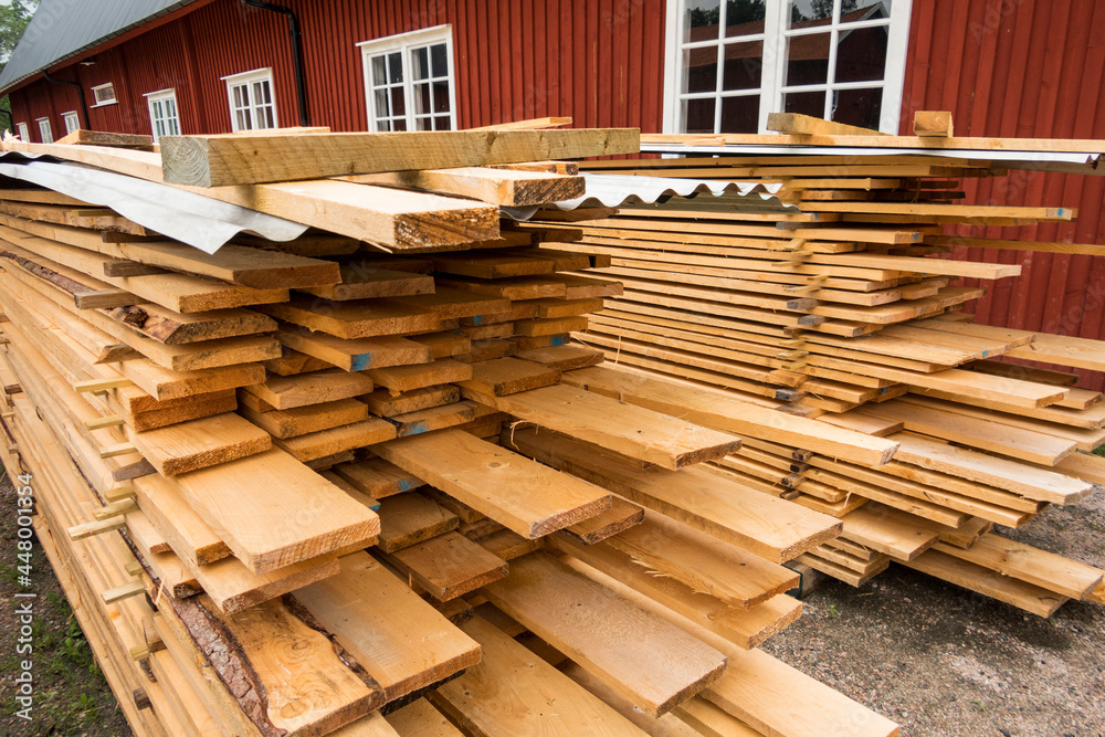 Hofsnas, Sweden Piles of fresh timber piled high waiting for a siding job. Hofsnas, Sweden Piles of fresh timber piled high waiting for a siding job.