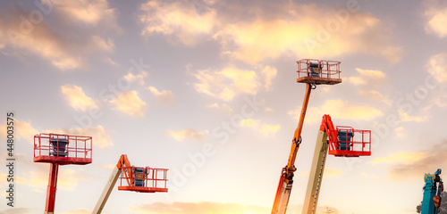 Articulated boom lift. Aerial platform lift. Telescopic boom lift against the sky. Mobile construction crane for rent and sale. Maintenance and repair hydraulic boom lift service. Crane dealership.