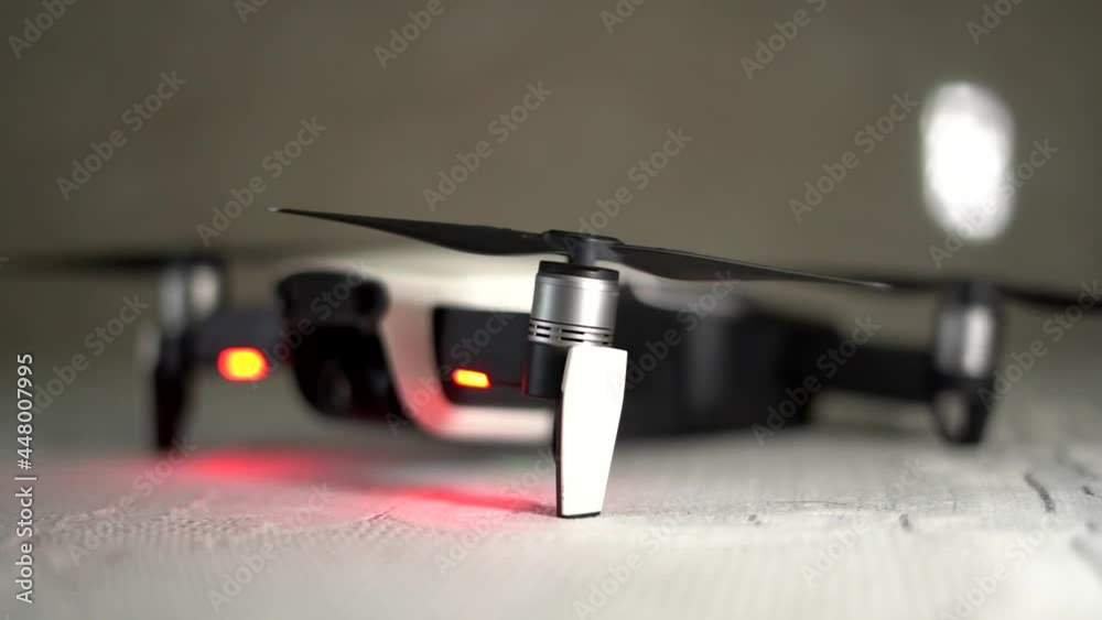 drone mavid air dji propellor spinning and stoping in slow motion side view. drone mavid air dji propellor spinning and stoping in slow motion side view.
