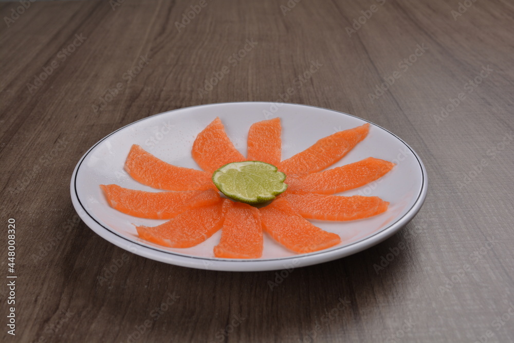 Chinese New Year festival colourful Yu Sheng Lo Hei salad with smoked salmon fish, cracker cookies and sweet sauce on wood background asian halal menu Chinese New Year festival colourful Yu Sheng Lo Hei salad with smoked salmon fish, cracker cookies and sweet sauce on wood background asian halal menu