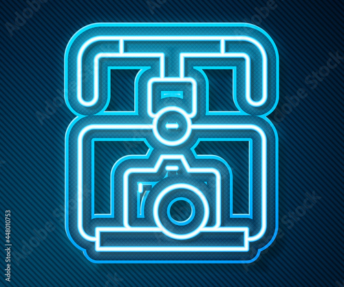 Glowing neon line Gimbal stabilizer with DSLR camera icon isolated on blue background. Vector
