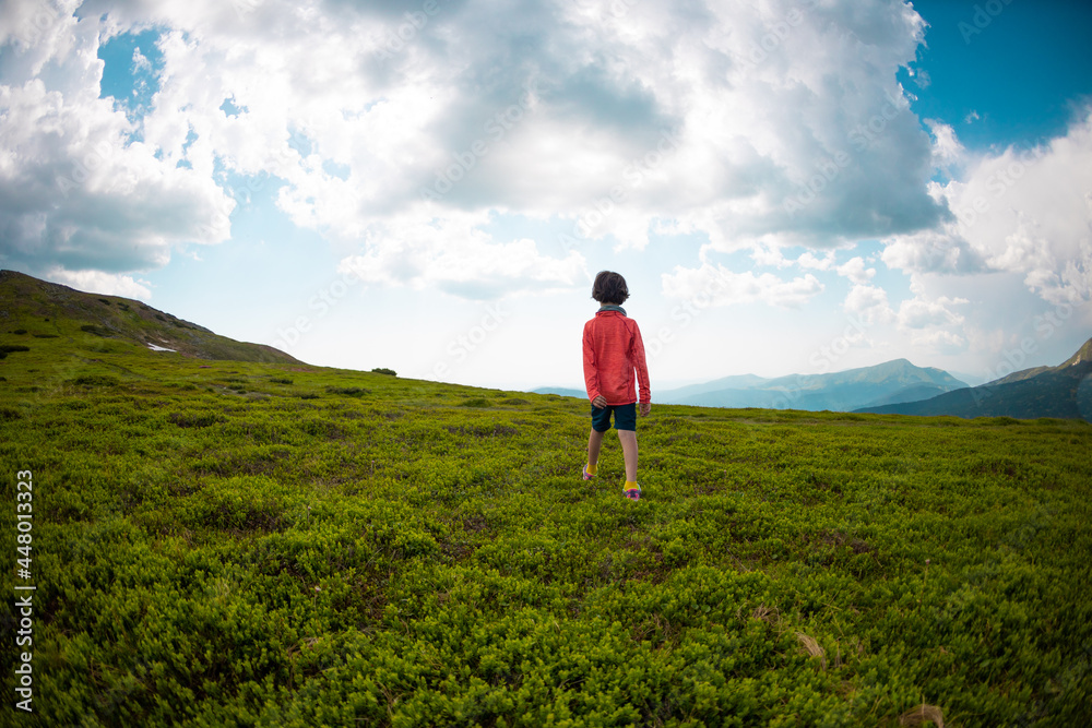 boy walks along a mountain path.. boy walks along a mountain path..