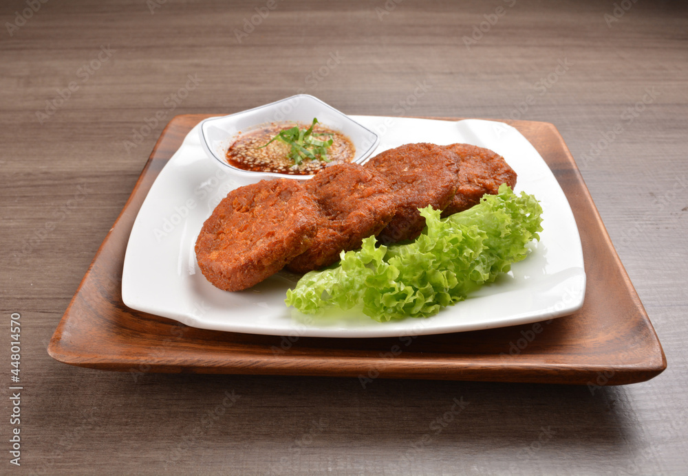 deep fried hash brown round potato cake with Thai spicy chilli sauce on wood background asian halal vegan menu deep fried hash brown round potato cake with Thai spicy chilli sauce on wood background asian halal vegan menu
