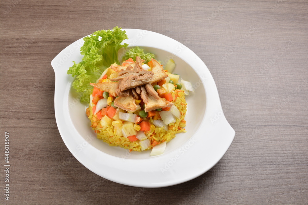 vegetarian nasi goreng fried rice with pineapple, vegetables meat in spicy chilli sambal sauce on wood background asian halal vegan menu vegetarian nasi goreng fried rice with pineapple, vegetables meat in spicy chilli sambal sauce on wood background asian halal vegan menu