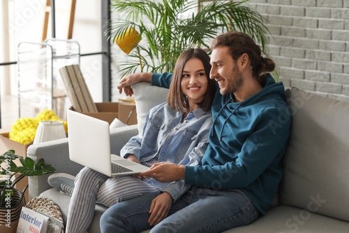 Young couple using laptop i...