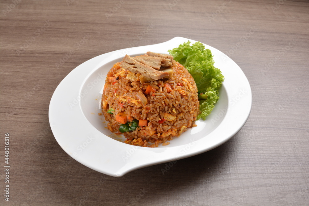 vegetarian nasi goreng fried rice with pineapple, vegetables meat in spicy chilli sambal sauce on wood background asian halal vegan menu vegetarian nasi goreng fried rice with pineapple, vegetables meat in spicy chilli sambal sauce on wood background asian halal vegan menu