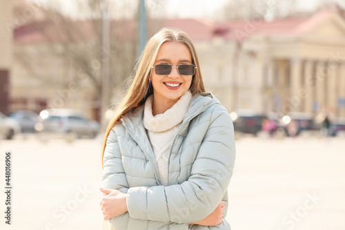 Young woman wearing stylish sunglasses outdoors