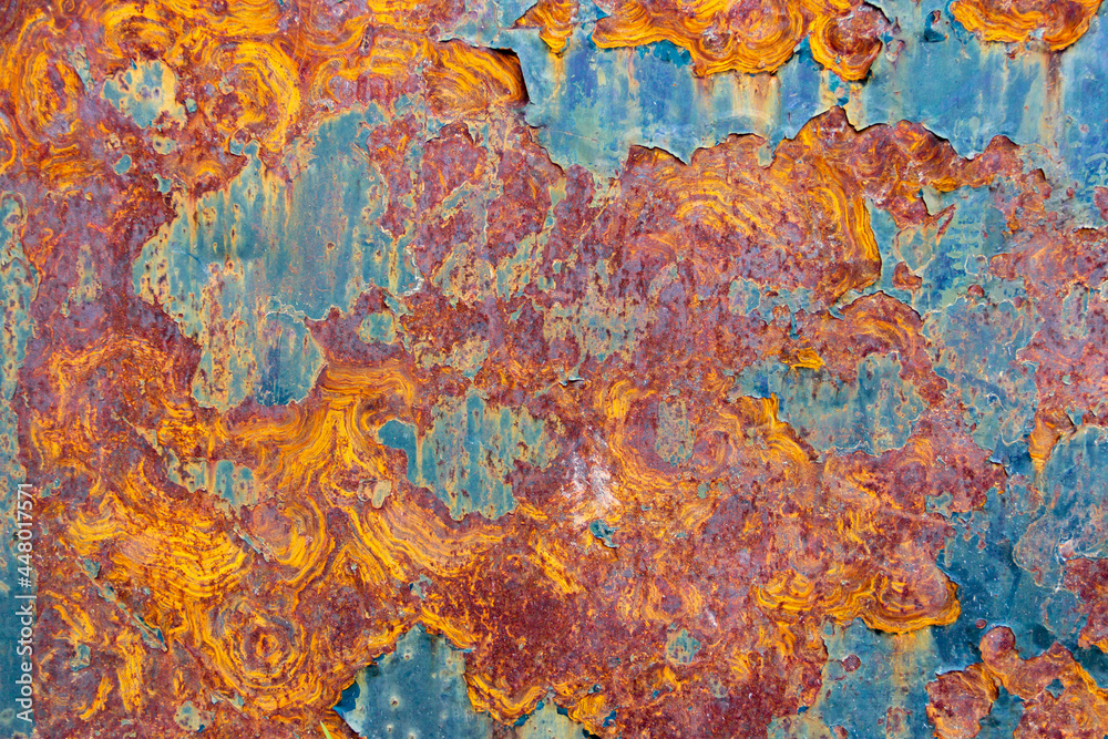 Paint and rust texture of orange, red, yellow and cyan colors. Industrial background.