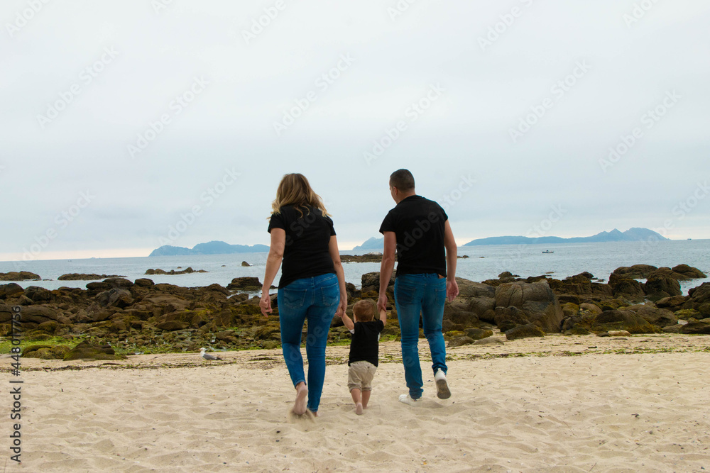 family walking on the beach family walking on the beach