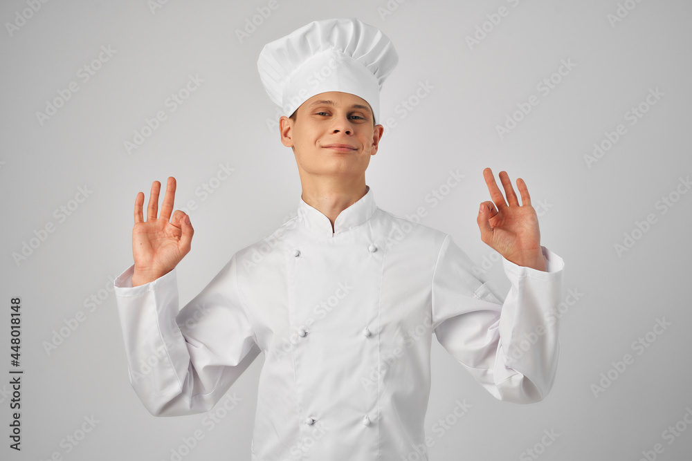 a man in a chef's uniform gesturing with a hand working in a restaurant professional a man in a chef's uniform gesturing with a hand working in a restaurant professional