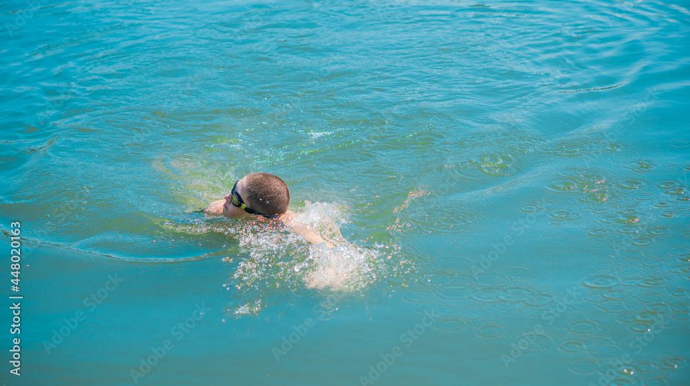 13 years Teenage boy swimming in lake, Children lifestyle. Enjoy the life