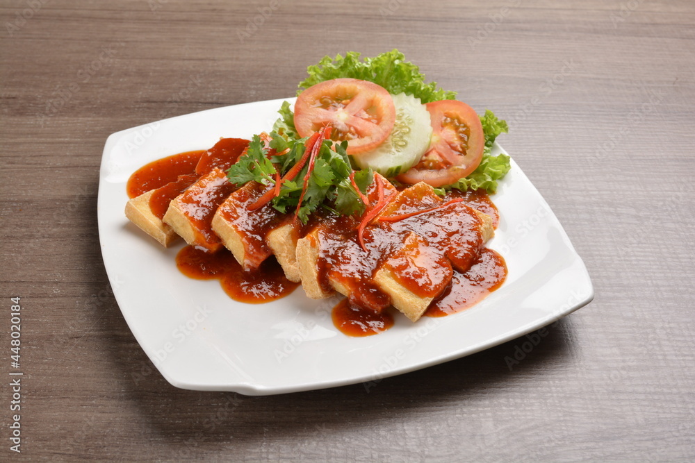 deep fried bean curd tofu with spicy sambal chilli sauce on wood background asian halal vegan menu deep fried bean curd tofu with spicy sambal chilli sauce on wood background asian halal vegan menu