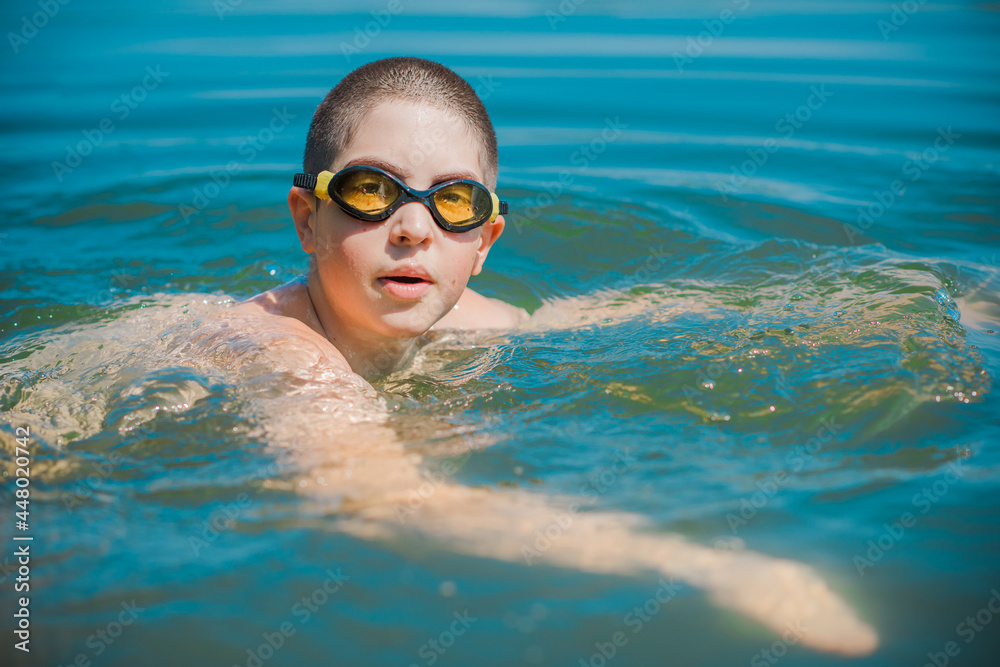 13 years Teenage boy swimming in lake, Children lifestyle. Enjoy the
