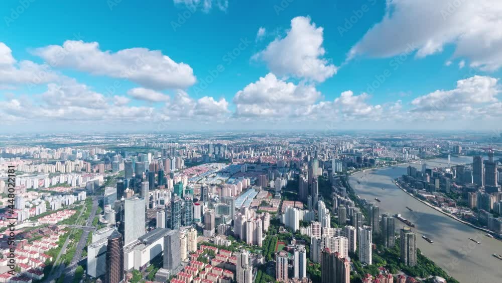 Time lapse of shanghai city in cloudy afternoon, aerial view of Shanghai skyline, ships sailing on Huangpu river, busy traffic on road, clouds moving and shadows follow, 4k footage, tilt up shot. Time lapse of shanghai city in cloudy afternoon, aerial view of Shanghai skyline, ships sailing on Huangpu river, busy traffic on road, clouds moving and shadows follow, 4k footage, tilt up shot.