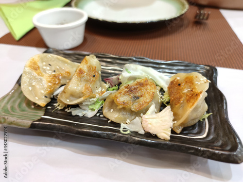 Closeup of  Japanese dumpling gyozas stuffed with meat photo