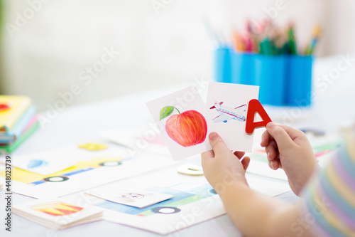 Photos Kid learning to read. Phonics flash cards.