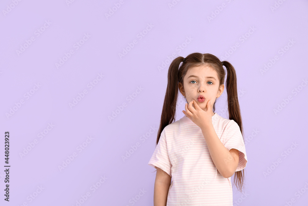 Little girl training pronounce letters on color background Little girl training pronounce letters on color background
