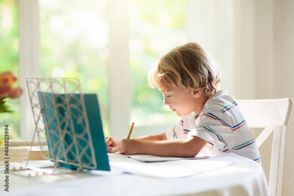 Online remote learning. School kid doing homework. Online remote learning. School kid doing homework.