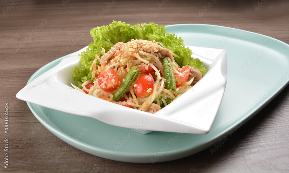 thai cold mango papaya vegetable salad in spicy sour lime sauce on wood background asian halal vegan menu thai cold mango papaya vegetable salad in spicy sour lime sauce on wood background asian halal vegan menu