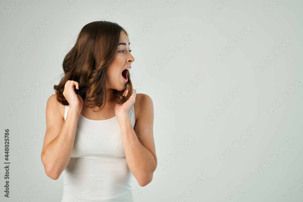 cheerful brunette in a white t-shirt fashionable hairstyle studio lifestyle cheerful brunette in a white t-shirt fashionable hairstyle studio lifestyle