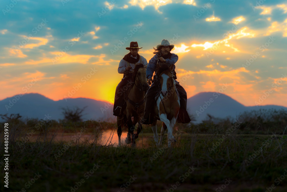 Cowboy silhouette riding a horse When the sunset looks beautiful
