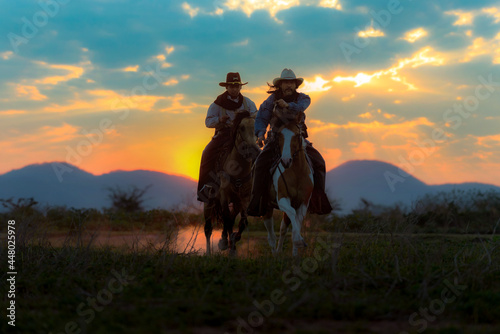 Cowboy silhouette riding a horse When the sunset looks beautiful 