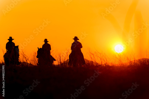 Cowboy silhouette riding a horse When the sunset looks beautiful
