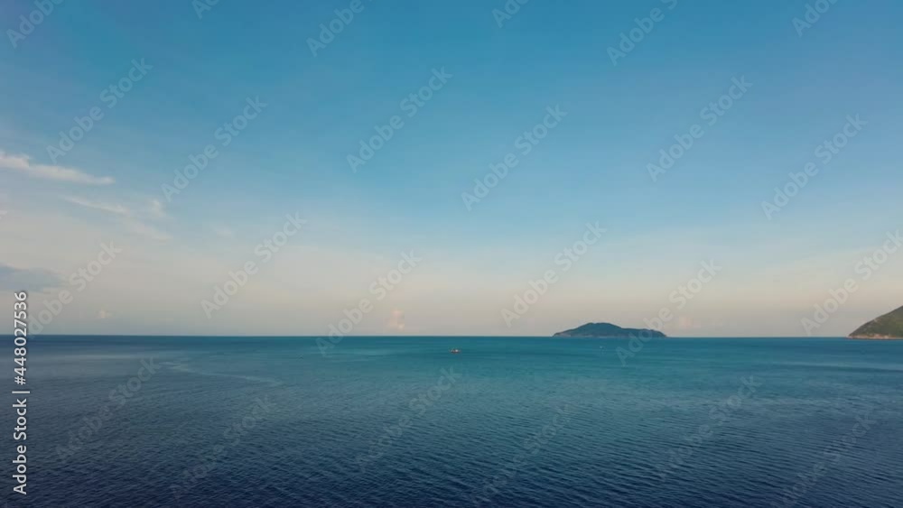 Time-lapse of the tropical island and some fishing boats in the tranquil sea Time-lapse of the tropical island and some fishing boats in the tranquil sea