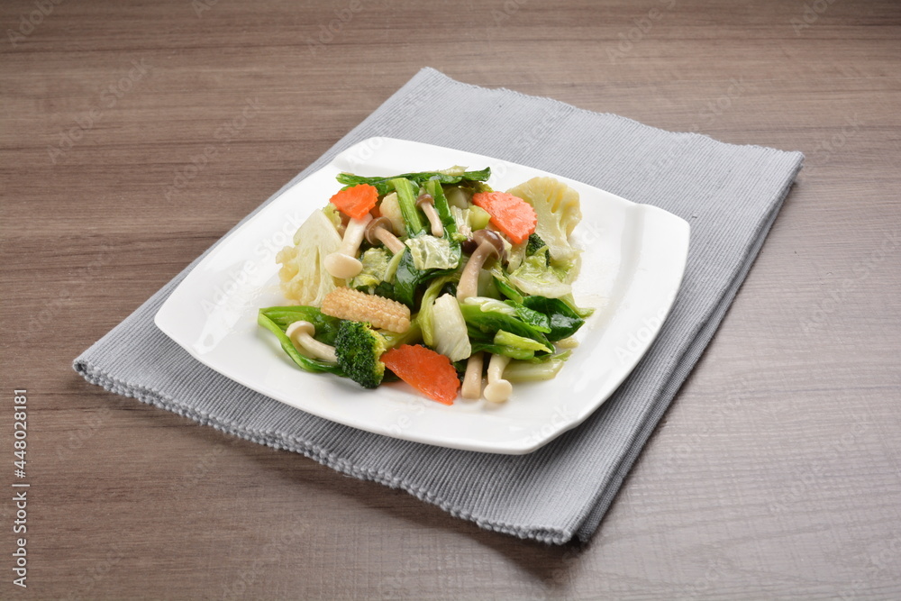 stir fried mixed vegetable and carrot in soy sauce on wood background asian halal vegan menu