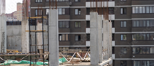 Finished residential building and unfinished residential building. Housing construction site  apartment block with scaffolding