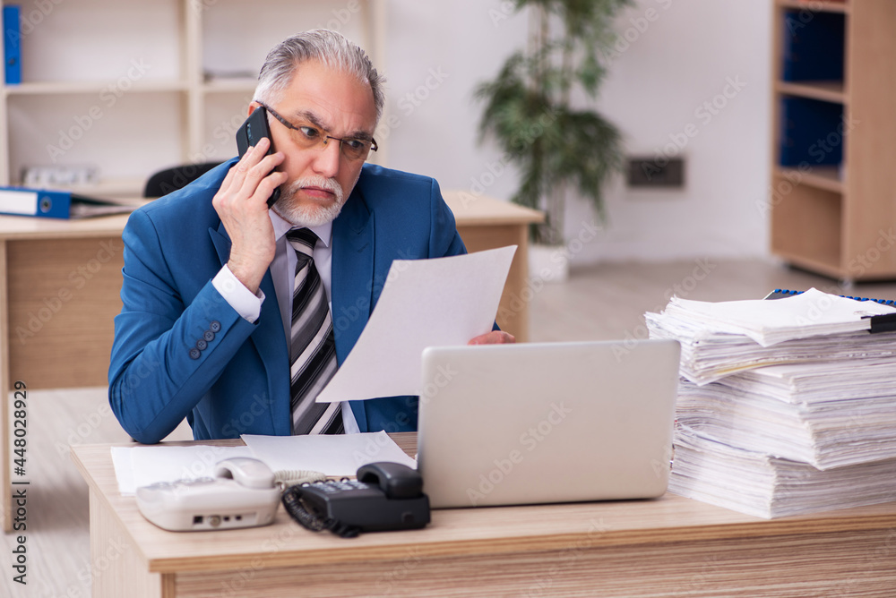 Old male employee and too much work in the office Old male employee and too much work in the office